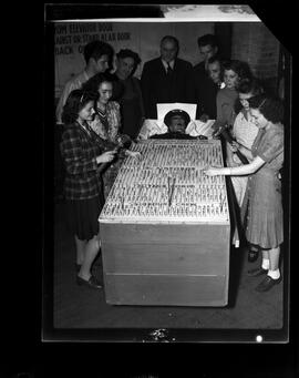 Goodrich Co., B. F. carving nails in Hitler's coffin